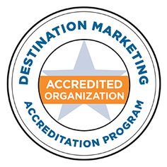 a badge with the words, destination marketing and an orange star in the center that reads