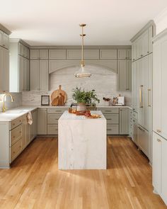 a kitchen with wooden floors and gray cabinets