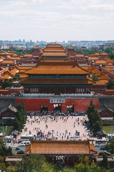 an aerial view of the forbidden city with many buildings and people walking in front of it