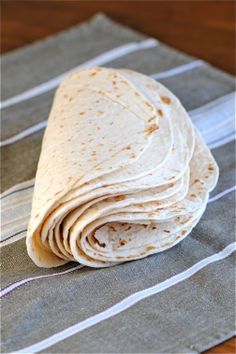 a tortilla sitting on top of a striped napkin