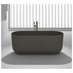 a bathtub sitting in front of a window with blinds on it's side