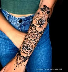 a woman's arm with flowers on it