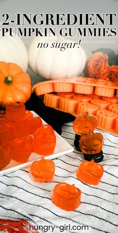 two ingredient pumpkin gummies are sitting on a table next to some orange candies