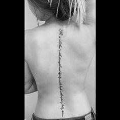 the back of a woman's neck with writing on it