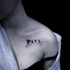 a black and white dog tattoo on the chest