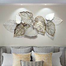 a bed with pillows and decorative wall art above it