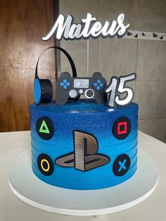 a blue cake with video game controllers on it