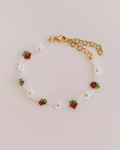 a bracelet with flowers and pearls on it