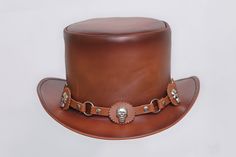 Description: * High-Quality Craftsmanship hand made * Real Leather * 100% pure leather **Those living in remote areas will have to pay $50 extra as shipping charges before the item is shipped. Sizing Heads come in all sizes, and in a lots variety of shapes. Although high quality hats are adaptable, and will usually conform to differences in shape with a little wearing, it is essential that the size be correct for the head. To determine your hat size, measure the circumference around your head, k Brown Leather Hats For Festivals, Leather Brimmed Hat For Festivals, Leather Brimmed Festival Hats, Leather High Crown Top Hat For Festival, Custom Handmade Brown Top Hat, Steampunk Leather Hat Band With Short Brim, Vintage Leather Hat Bands For Flat Crown, Festival Leather Hat Bands In Brown, Brown Steampunk Hat With Short Brim