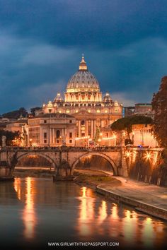 the dome of st peter's cathedral lit up at night in rome, italy