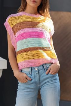 A colorful stripe sweater top with a cap sleeve look and comfortable fit. This sweater top has vibrant colors and a mock neckline. Style with jeans and sneakers for a casual look. Model is 5'10" and wearing her true size Small. Small: Bust 20.75", Length 21" 100% Viscose Pink Stretch Crochet Top Casual Style, Crochet Cap Sleeve, Casual Pink V-neck Crochet Top, Spring Yarn-dyed Short Sleeve Tops, Blue Yarn-dyed Short Sleeve Tops, Spring Multicolor Hand-knitted Crochet Top, Loose Fit Sweater, Crochet Cap, Mock Neckline