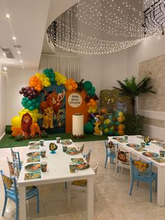 a room filled with lots of tables covered in balloons and animals on top of them