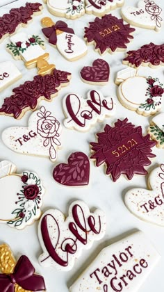 decorated cookies are arranged in the shape of hearts and flowers, with names on them