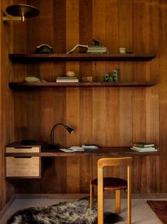 a chair and desk in a room with wood paneling