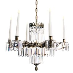 a chandelier with five candles hanging from it