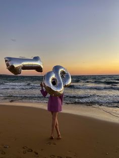 ginger haired girl at the beach holding helium metallic balloons wearing purple blazer dress standing on the sand and watching the waves and sunset. Beach Photoshoot With Dress, Birthday Dresses Summer, Birthday Shoot At The Beach, Bday On The Beach, Birthday Beach Pictures Aesthetic, Beach Debut Photoshoot, Birthday Shoot Beach, Birthday Photo Outdoor, Cute Bday Dresses