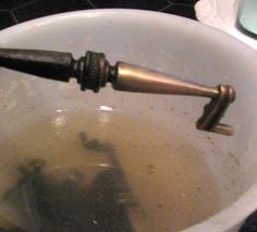 an old water faucet in a white bucket