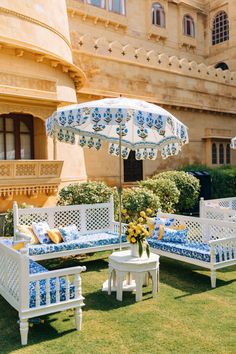 an outdoor seating area with blue and white furniture