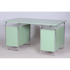 a green desk with two drawers on each side