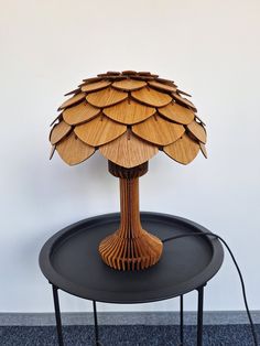 a wooden lamp sitting on top of a black table