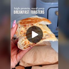 a person holding a sandwich in their hand with the words, high protein meal prep breakfast toasters