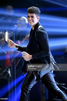 the singer is seen performing on stage during his concert at the arena in cologne, germany