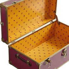 an open suitcase sitting on top of a white floor next to a yellow and purple wall