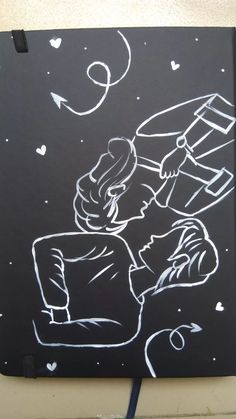 a drawing of a boy holding a kite on top of a blackboard with white writing