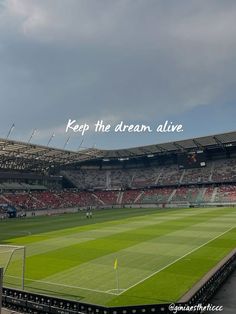 an empty soccer stadium with the words keep the dream alive