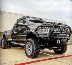 a large black truck parked in a parking lot