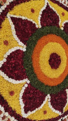 a circular design made out of flowers on the ground