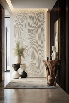 a room with two vases and a wooden table in front of a large wall