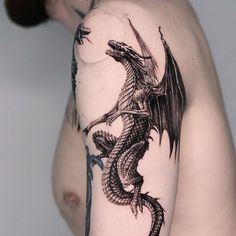 a man with a dragon tattoo on his arm