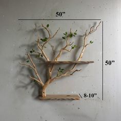 a wooden shelf with a tree on it and measurements for the top part of the shelf