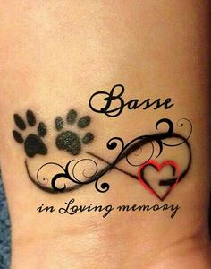 a dog's paw with the words base in loving memory on its ankle tattoo