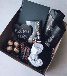 an open box filled with various items and some sort of chocolates on top of it