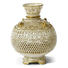 a white vase with gold trimmings on the top and bottom, sitting in front of a white background