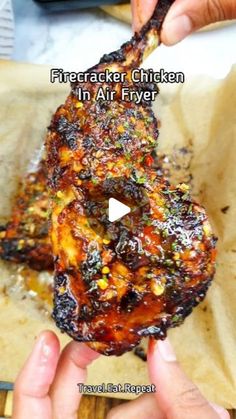 someone is holding up a piece of chicken in their hand with the words, firecracker chicken in air fryer