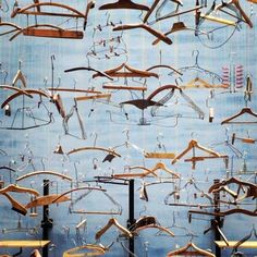 many different types of clothes hangers in a room with blue walls and flooring