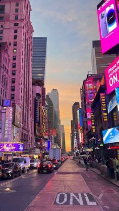 a city street filled with lots of tall buildings and neon signs on the side of it