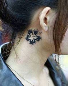 a woman with a flower tattoo on her left side of her neck and behind her ear