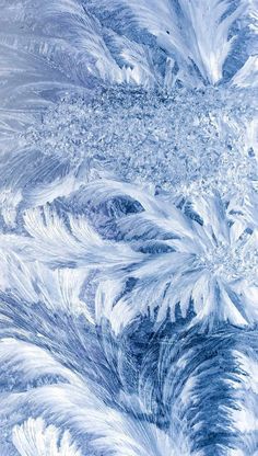 an abstract blue and white background with lots of snow flakes on it's surface