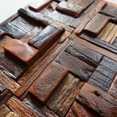 a close up of a wooden wall made out of different types of wood planks