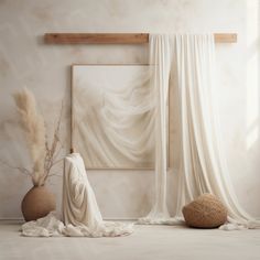 a white room with two vases on the floor and a painting hanging above it