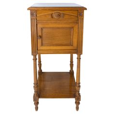 an antique wooden nightstand with marble top