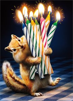 a small squirrel is holding some birthday candles