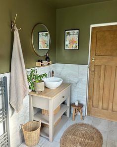 a bathroom with green walls and two sinks