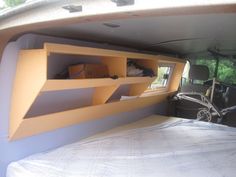 the interior of a van with shelves in the back