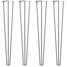 three tall metal poles sitting next to each other