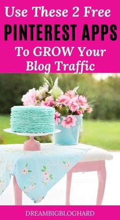 a blue cake sitting on top of a table next to pink flowers and a potted plant